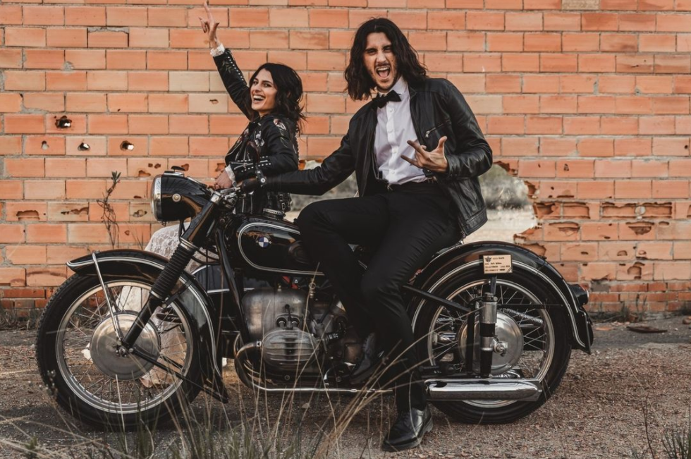 Couple on the motorcycle, dressed in leather jackets