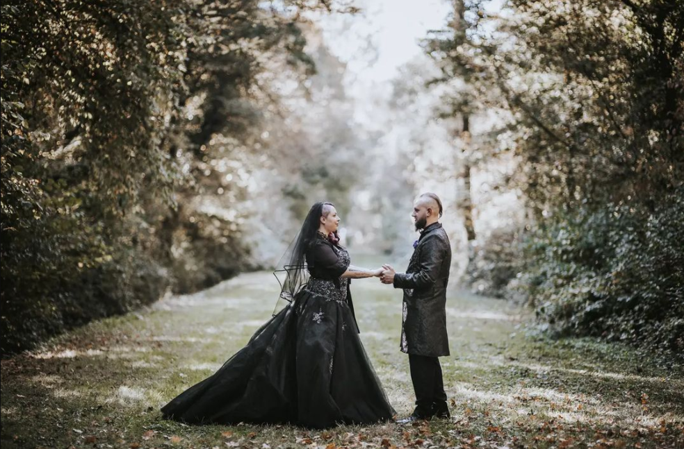 Wedding couple in the forest in gothic style outfits