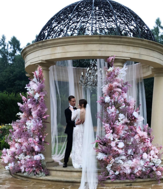 Wedding couple, purple flowers, altar in the garden