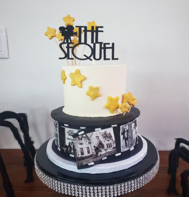 Movie themed wedding cake with two levels and camera topper