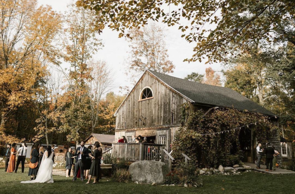 Rustic barn in New England, old, greyish wood, theme wedding with dressed up guests