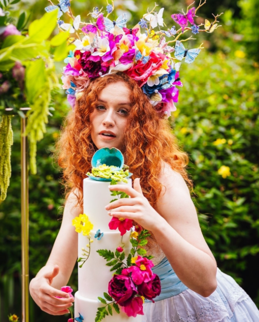Colorful Bride with wedding cake decorated with flowers