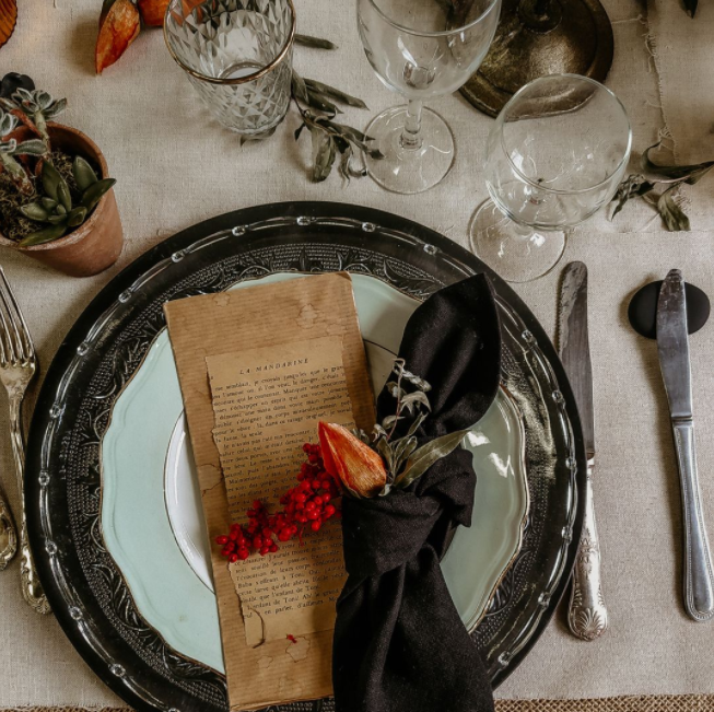 White and black plates, dark details, vintage utensils, old paper stationery, succulents in the pot