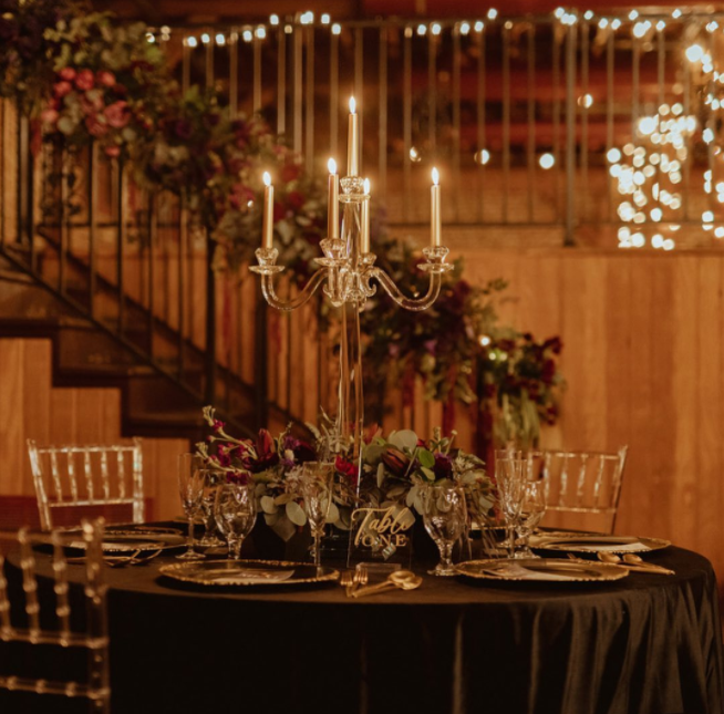 Glass candelabra with long silver candles, plastic transparent chair, led lights