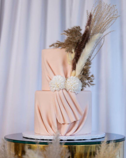 Pastel, draped dirty pink two level wedding cake decorated with pampa grass and mini chrysanthemum